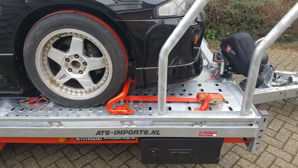 Wheel secured to the trailer with a strap