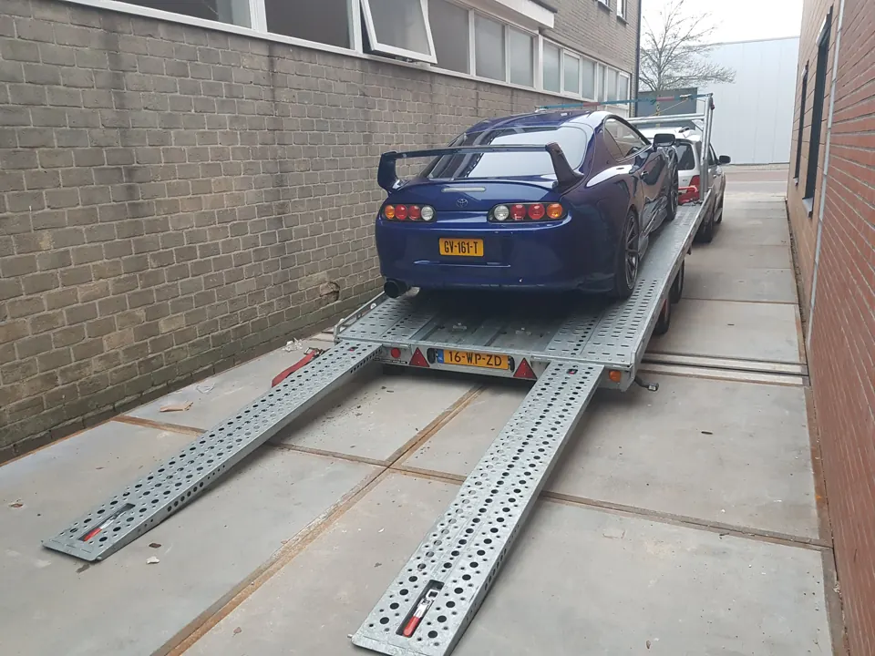 Blue Toyota Supra on a trailer