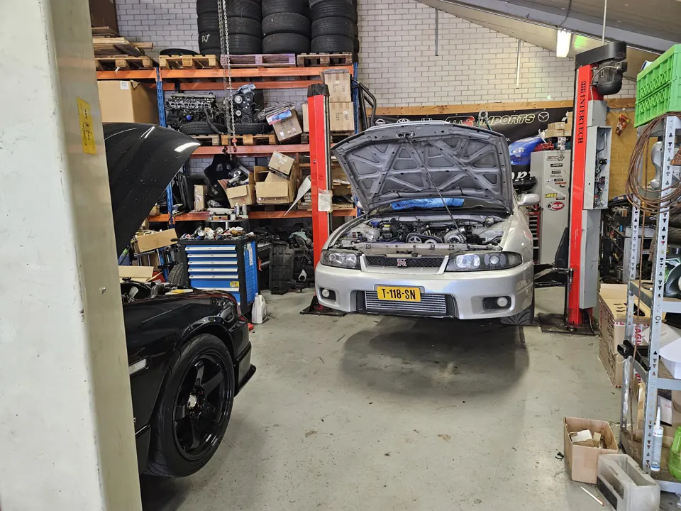 Nissan Skyline with open bonnet on a lift