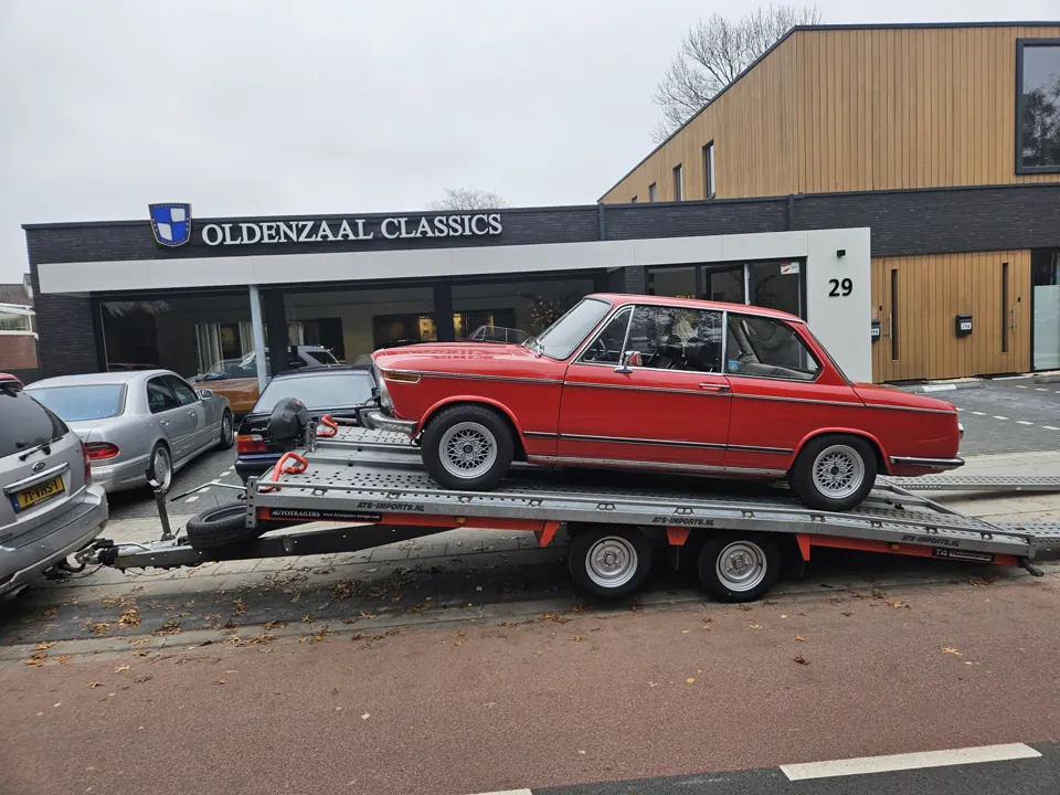 Red classic BMW on a trailer