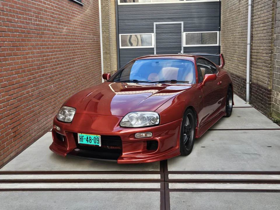 Red Toyota Supra MK4 outside the workshop