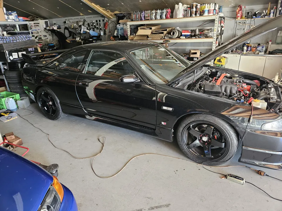 Black Skyline with its bonnet open in the workshop