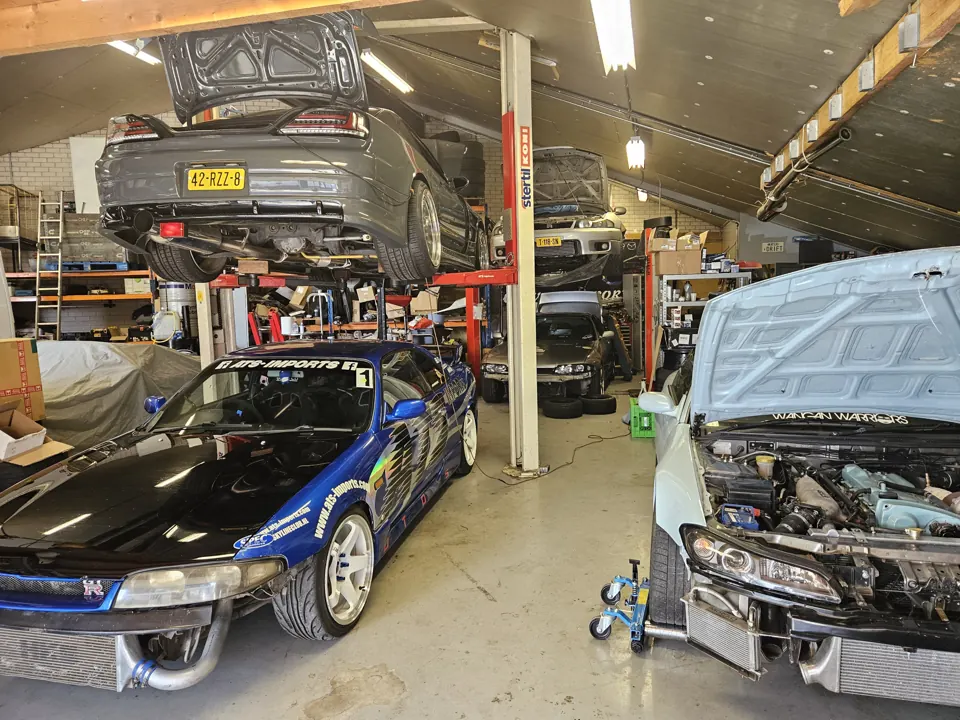 ATS Imports workshop with cars on lifts